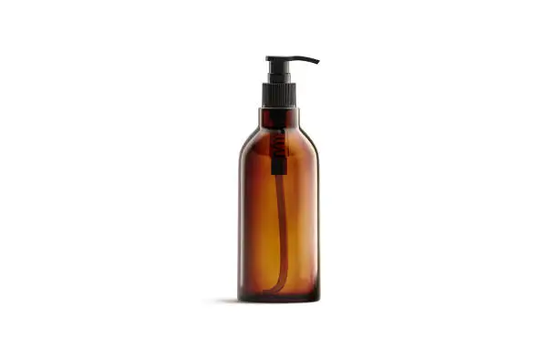 Blank amber glass pump bottle for oil mockup isolated, 3d rendering. Empty salve or balsam jar mock up, front view. Clear brown tube with oily or foam for spa healthcare mokcup template.