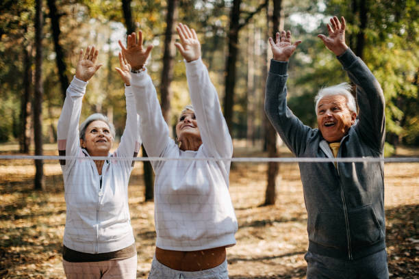 istock Multigenerational group of people plays volleyball 1188630573