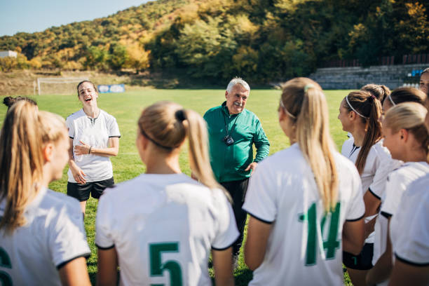 istock Girls soccer team with coach on training 1188630650