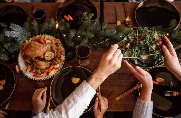 istock Winter holidays dinner table with turkey, vegetables and wine. Cozy atmosphere. 1188631928