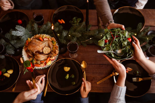 istock Winter holidays dinner table with turkey, vegetables and wine. Cozy atmosphere. 1188631959