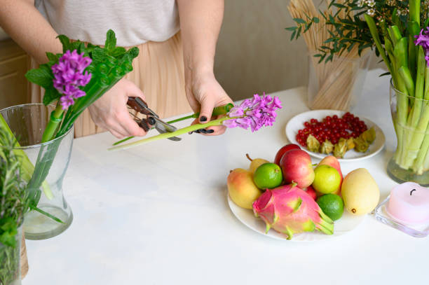 istock the process of forming a fruit and flower bouquet. tutorial, do it yourself. photo 10, women's hands pruning secateurs stems of pink hyacinth 1188637897