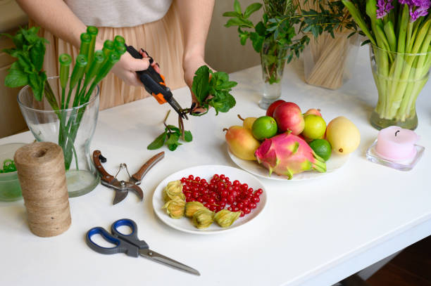 istock the process of forming a fruit and flower bouquet. tutorial, do it yourself. photo 8, women's hands pruning secateurs mint stalks 1188637935
