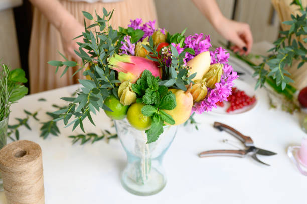 istock the process of forming a fruit and flower bouquet. tutorial, do it yourself. photo 25, almost finished bouquet in a vase 1188637969