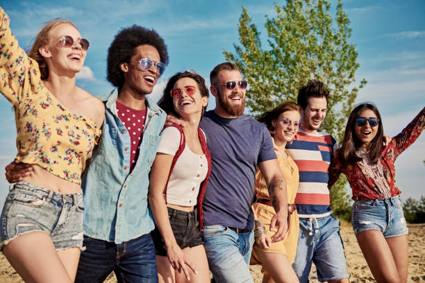 istock Young smiling people in a row on the fresh air 1188639006