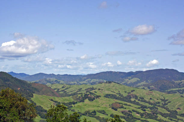istock Mountain range with lush green foliage and cloudy sky 1188639418