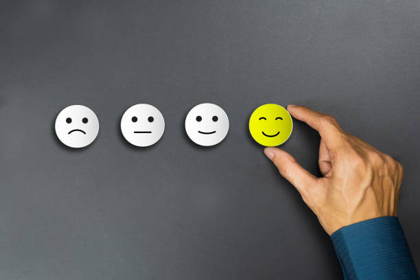istock Conceptual the customer responded to the survey. The client using hand choose happy face smile icon. Depicts that customer is very satisfied. Service experience and satisfaction concept. 1188641295
