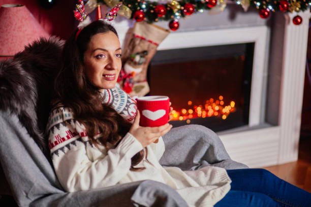 istock Cheerful woman with Christmas lights 1188641392