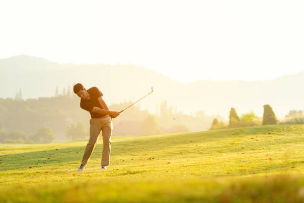 istock Professional Golfer asian man swing and hitting golf ball practice at golf driving range and fairway in sunny morning day on club golf. Lifestyle and Sport Concept 1188641421
