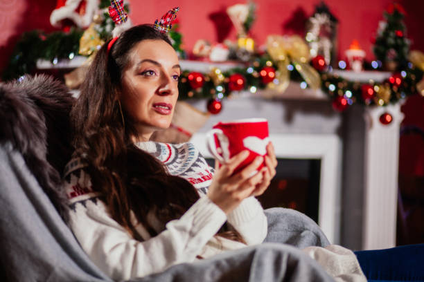 istock Cheerful woman with Christmas lights 1188641425
