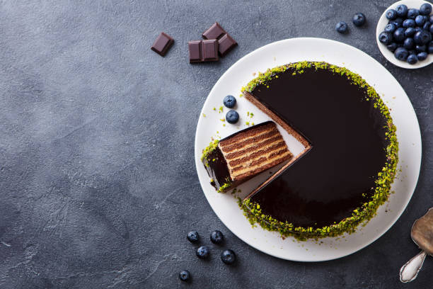 Chocolate cake on a plate. Grey stone background. Copy space. Top view.