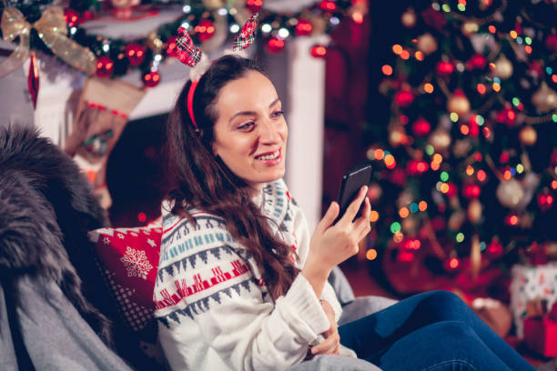 istock Cheerful woman with Christmas lights 1188641679