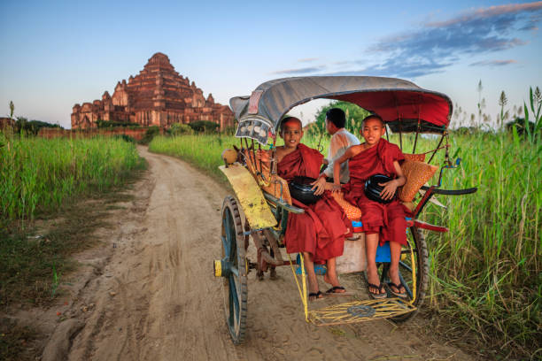 istock Young Buddhist monks on the horse cart 1188642738