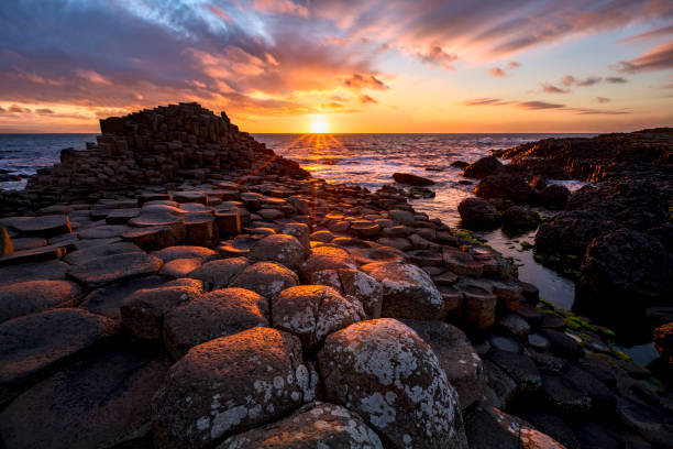 istock sunset over basalt columns Giant's Causeway, County Antrim, Northern Ireland 1188643146