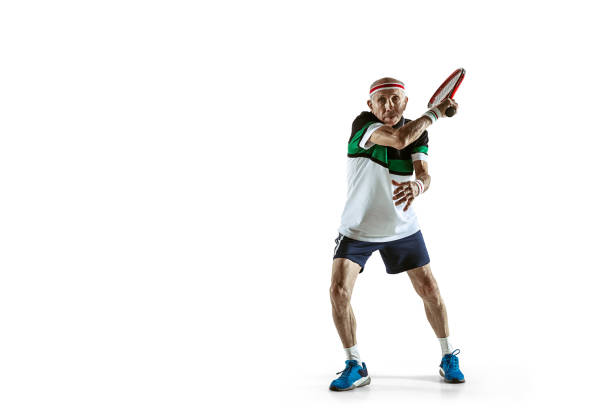 senior man playing tennis in sportwear isolated on white background - tennis active seniors healthy lifestyle senior men imagens e fotografias de stock