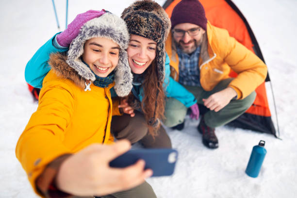 istock Happy family taking selfies on winter camping 1188643949
