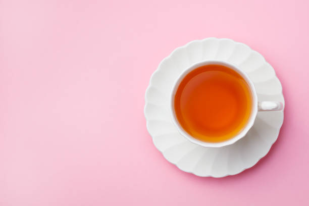 istock Tea in white cup on pink background. Copy space. Top view. 1188644733
