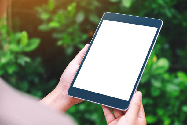 istock a woman holding black tablet pc with blank white desktop screen in the park 1188645708