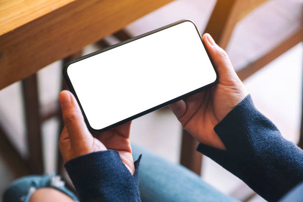 istock a woman holding black mobile phone with blank white screen in cafe 1188645716