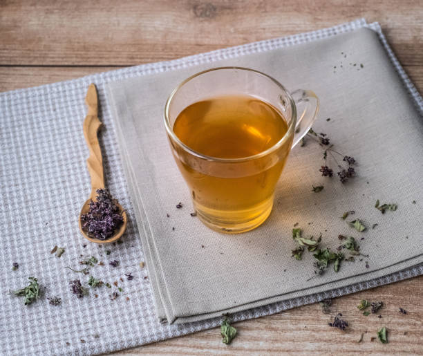 istock Warm oregano tea on beige linen napkins on the table. 1188646687
