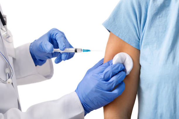 istock Unrecognizable doctor holding plastic syring, making vaccination injection 1188649153