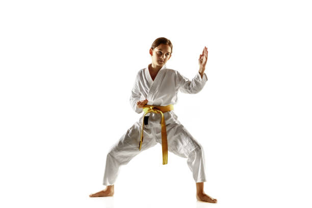 istock Confident junior in kimono practicing hand-to-hand combat, martial arts 1188651975