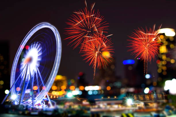 istock Fireworks Stock Image and Blurred Ferris Wheel 1188652269