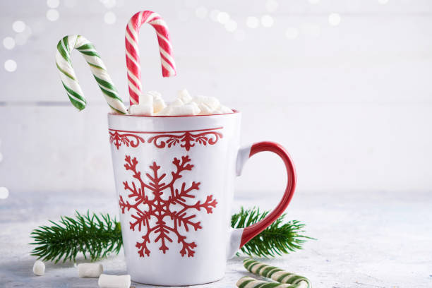 istock Christmas cup with sugar marshmallows and candy . Fir branches on light background Copy space. 1188652735