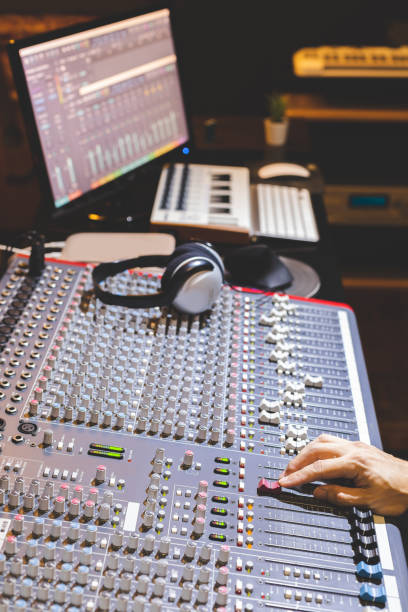 istock male producer, sound engineer hands working on audio mixing console in broadcasting, recording studio 1188655175