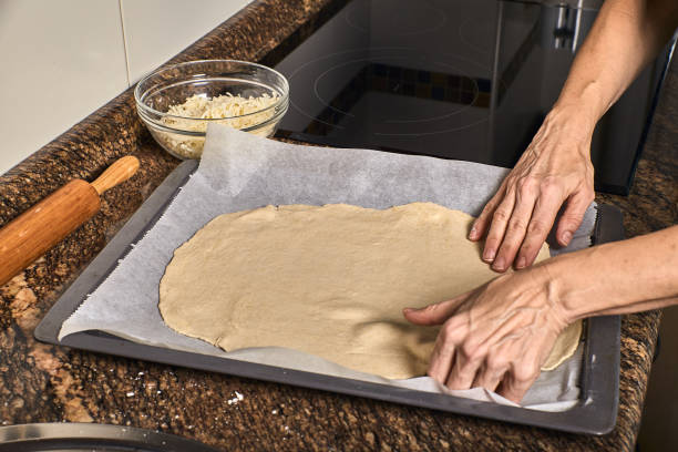 istock woman hands working on a pizza dough 1188658670