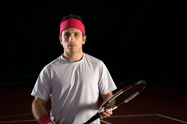 Young handsome african american sportsman playing tennis using racket over red background very happy and excited, winner expression celebrating victory screaming with big smile and raised hands