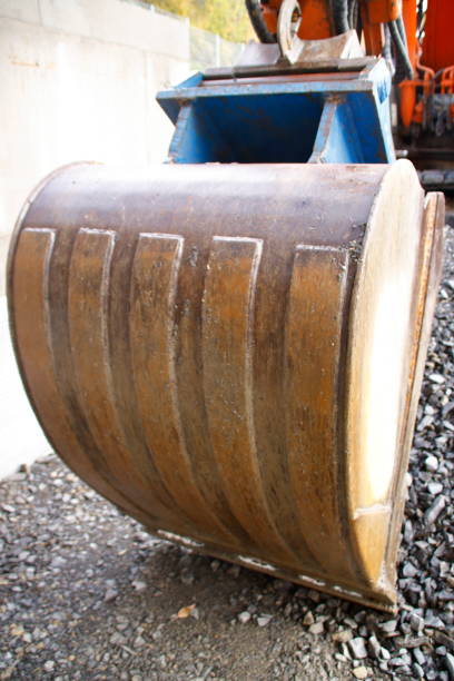 istock Excavator shovel digs into a gravel ground 1188659533