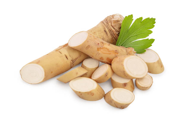 istock Horseradish root with slices and parsley isolated on white background 1188660505