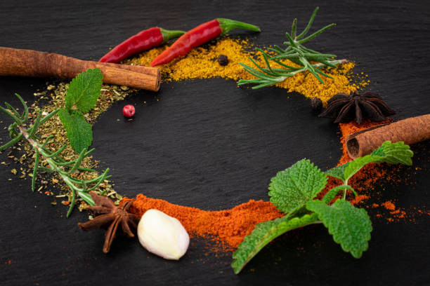 istock Colourful various herbs and spices on dark background 1188663990