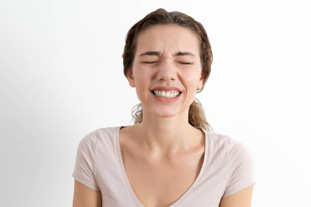 istock Young woman clenching teeth 1188664883