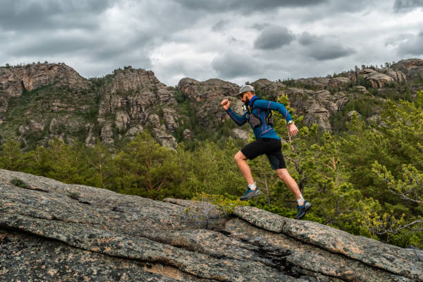 istock Male runner running on a mountain trail 1188665504