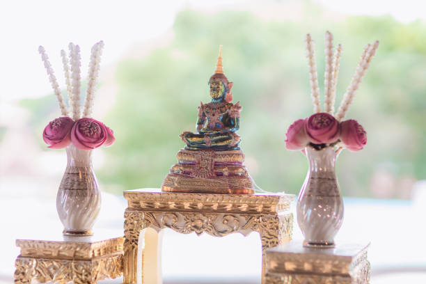 gold buddha statue on the table. symbol of buddhism religion in thai wedding ceremony. imagr for objects, and background. gold buddha statue on the table. symbol of buddhism religion in thai wedding ceremony. imagr for objects, and background. oracular stock pictures, royalty-free photos & images