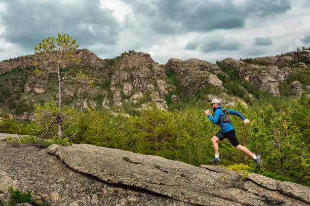 istock Male runner running on a mountain trail 1188665554