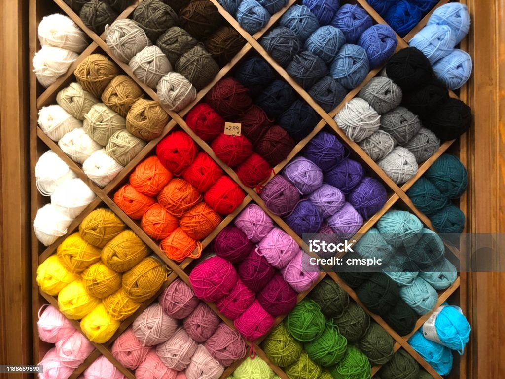 Wool in multiple colors Shop display with lots of different colored wool Ball Of Wool Stock Photo