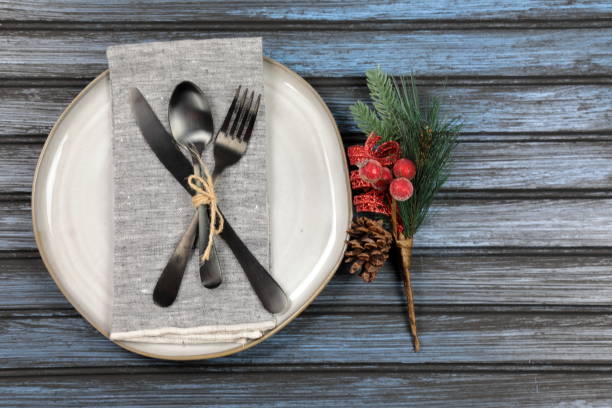 istock Overhead view of  table setting - a plate with spoon, fork and knife with a Christmas decoration 1188672519