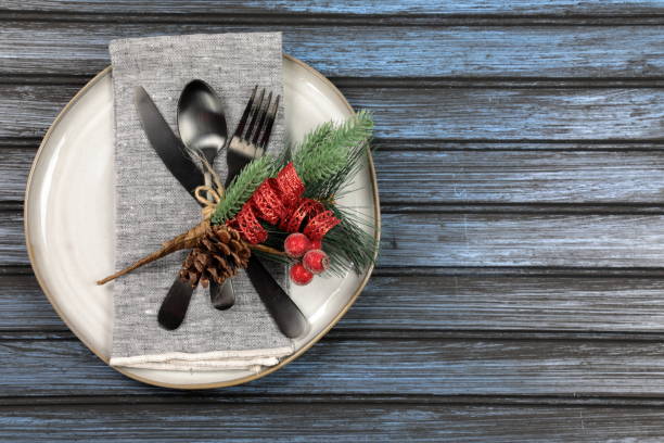 istock Overhead view of  table setting - a plate with spoon, fork and knife with a Christmas decoration 1188674453