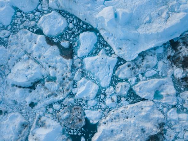 istock Icebergs drone aerial image top view - Climate Change and Global Warming. Icebergs from melting glacier in icefjord in Ilulissat, Greenland. Arctic nature ice landscape in Unesco World Heritage Site. 1188676560