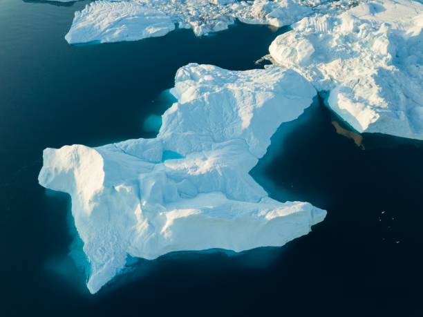 istock Icebergs drone aerial image top view - Climate Change and Global Warming. Icebergs from melting glacier in icefjord in Ilulissat, Greenland. Arctic nature ice landscape in Unesco World Heritage Site. 1188677919