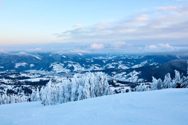 istock Winter rime and snow covered fir trees branches on mountainside on blue sky background on sunrise. Pine trees after heavy snowfall in the mountains on sunset. Backcountry ski resort frosty landscape 1188678412