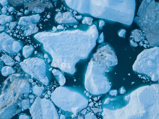 istock Icebergs drone aerial image top view - Climate Change and Global Warming. Icebergs from melting glacier in icefjord in Ilulissat, Greenland. Arctic nature ice landscape in Unesco World Heritage Site. 1188678460