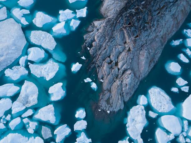 istock Icebergs drone aerial image top view - Climate Change and Global Warming. Icebergs from melting glacier in icefjord in Ilulissat, Greenland. Arctic nature ice landscape in Unesco World Heritage Site. 1188678579