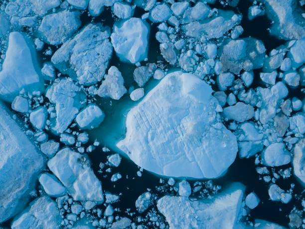 istock Icebergs drone aerial image top view - Climate Change and Global Warming. Icebergs from melting glacier in icefjord in Ilulissat, Greenland. Arctic nature ice landscape in Unesco World Heritage Site. 1188679753