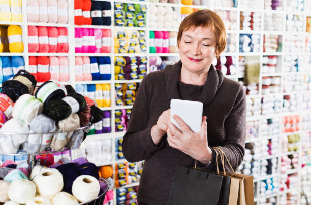 istock Woman  with needlework accessories and talking on phone 1188679988