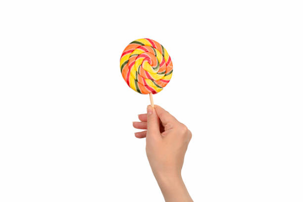 istock Lollipop in female hand isolated on white  background. Space for text or design. 1188680073