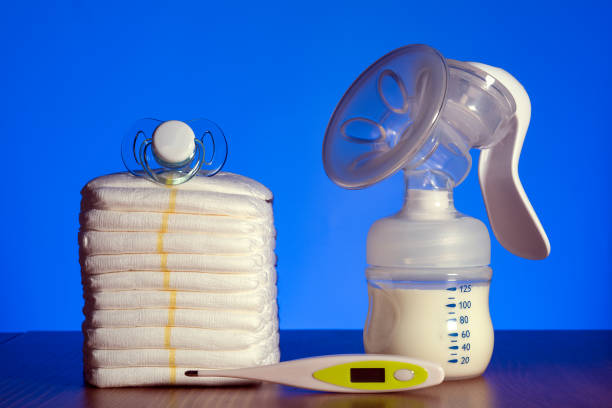 istock breast pump and nappies and thermometer with a pacifier on a blue background 1188680623